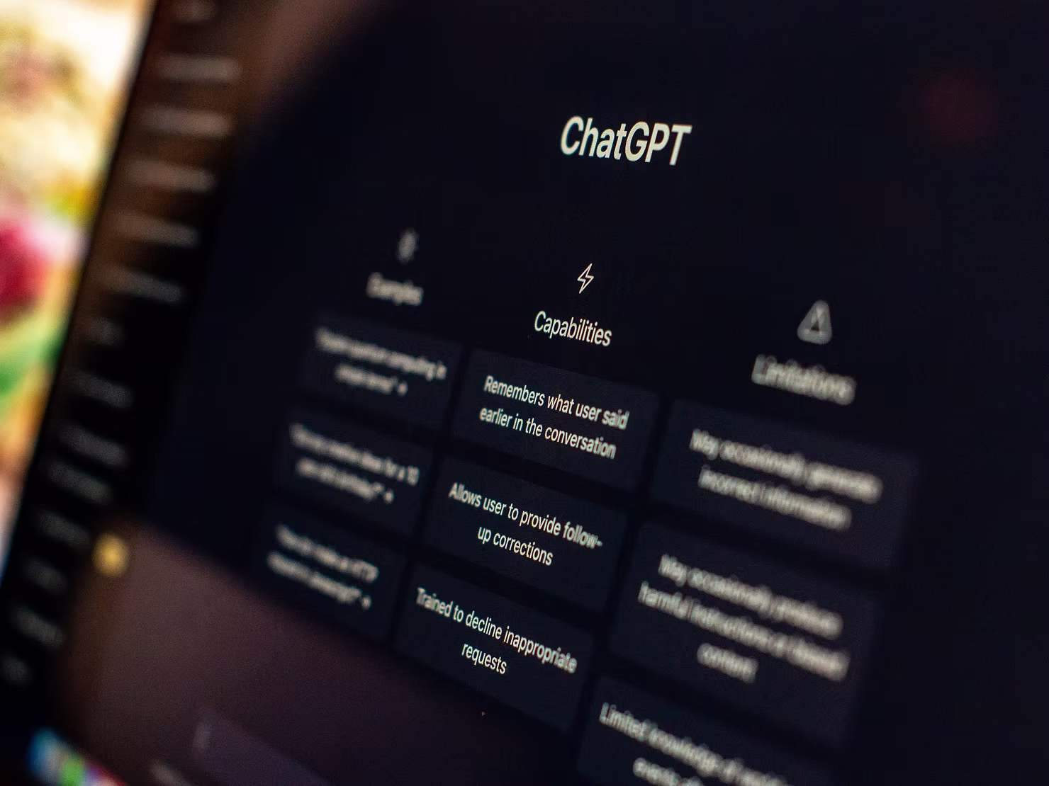 Close-up of a laptop screen showing the ChatGPT start page with its capabilities and limitations panels